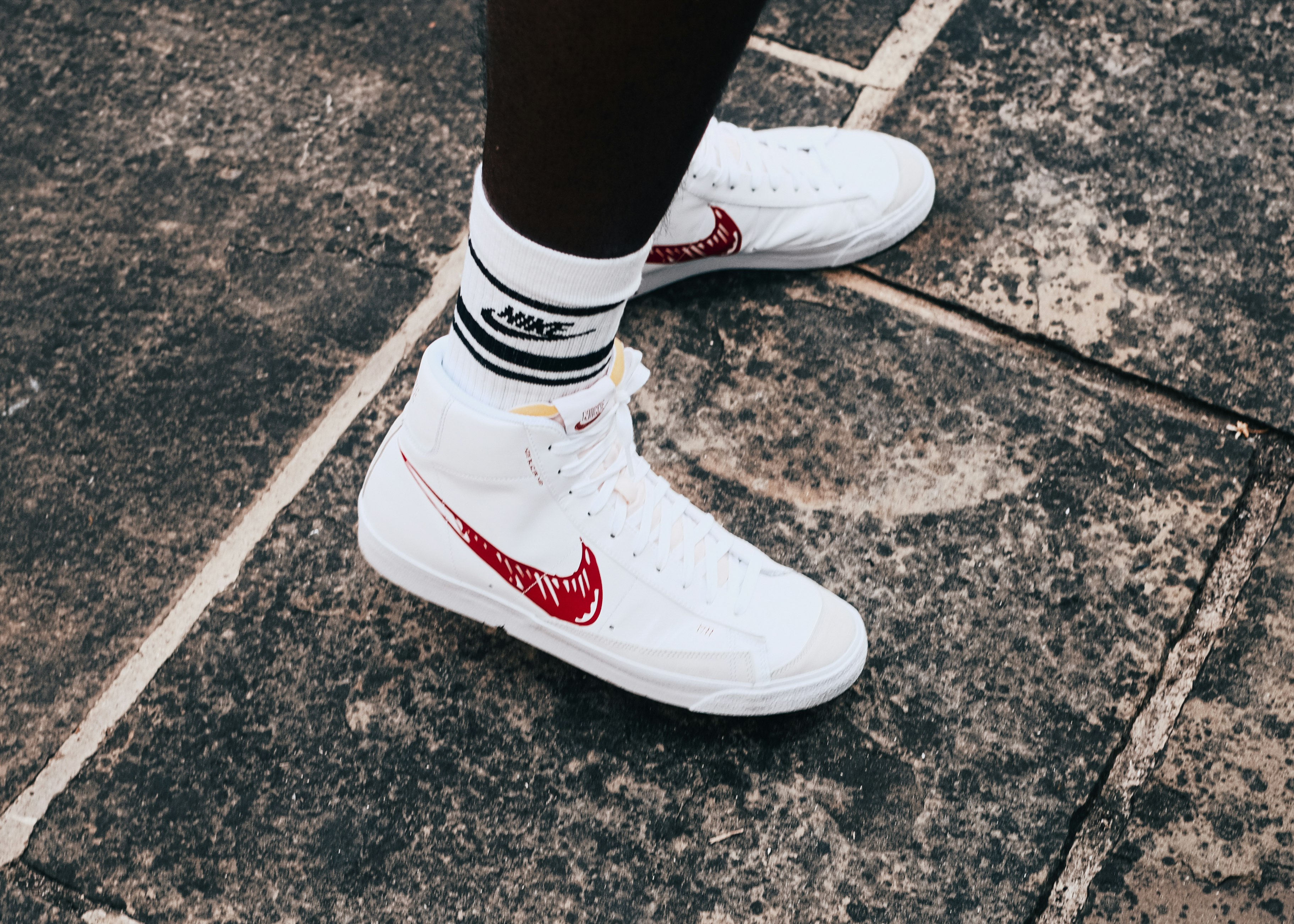 person wearing white nike air force 1 low